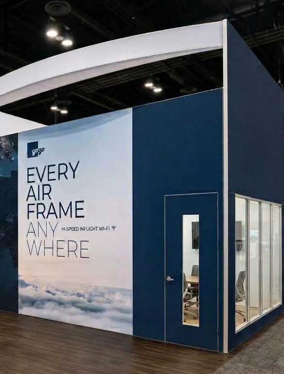 Gogo booth design for NBAA-BACE: a large Every Airframe Anywhere wall beside a navy wall with a door