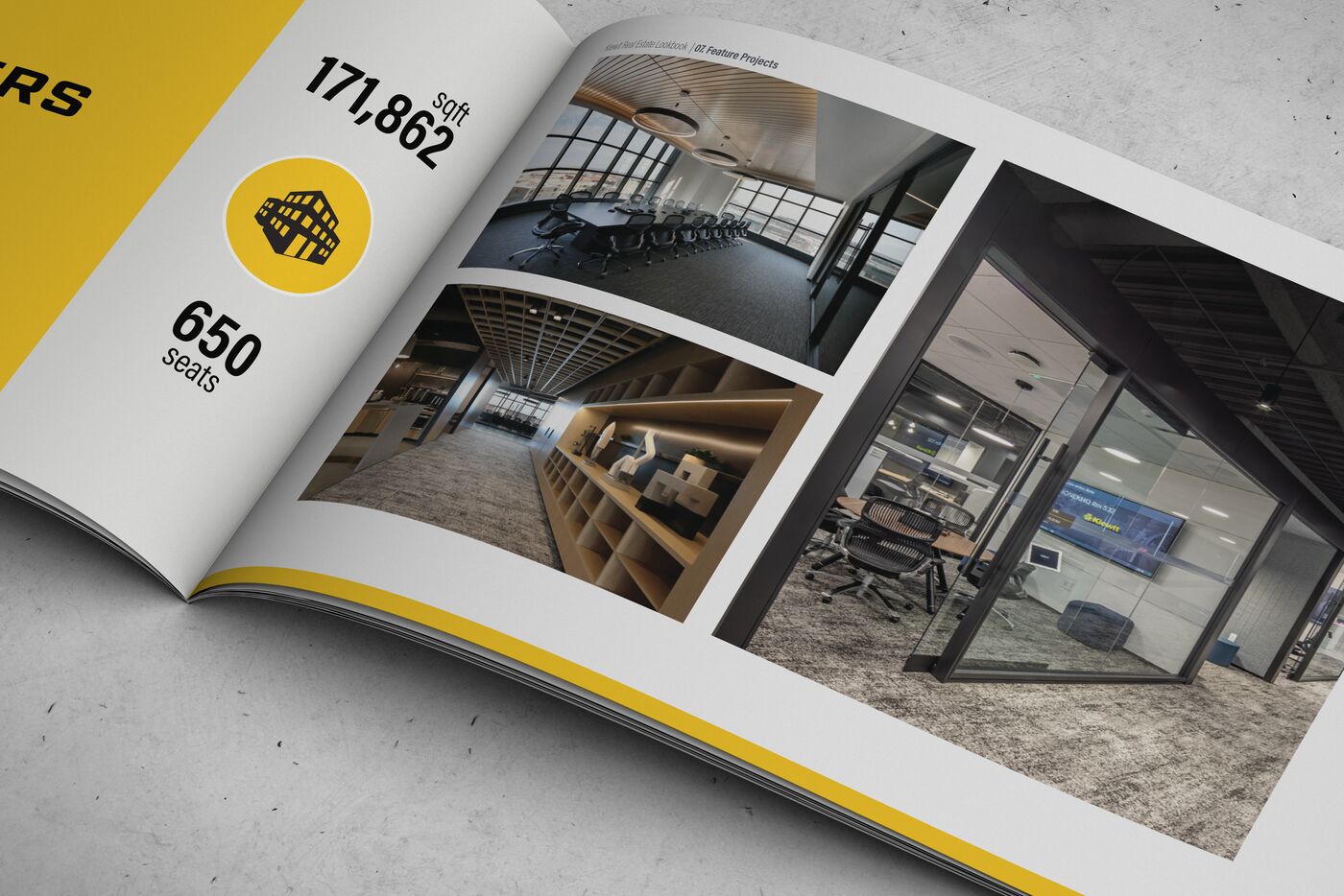 Printed Kiewit lookbook open on a concrete surface: a Feature Projects spread with interior photos of a boardroom, a library corridor and a glass meeting room, beside a yellow panel with 171,862 sqft and 650 seats