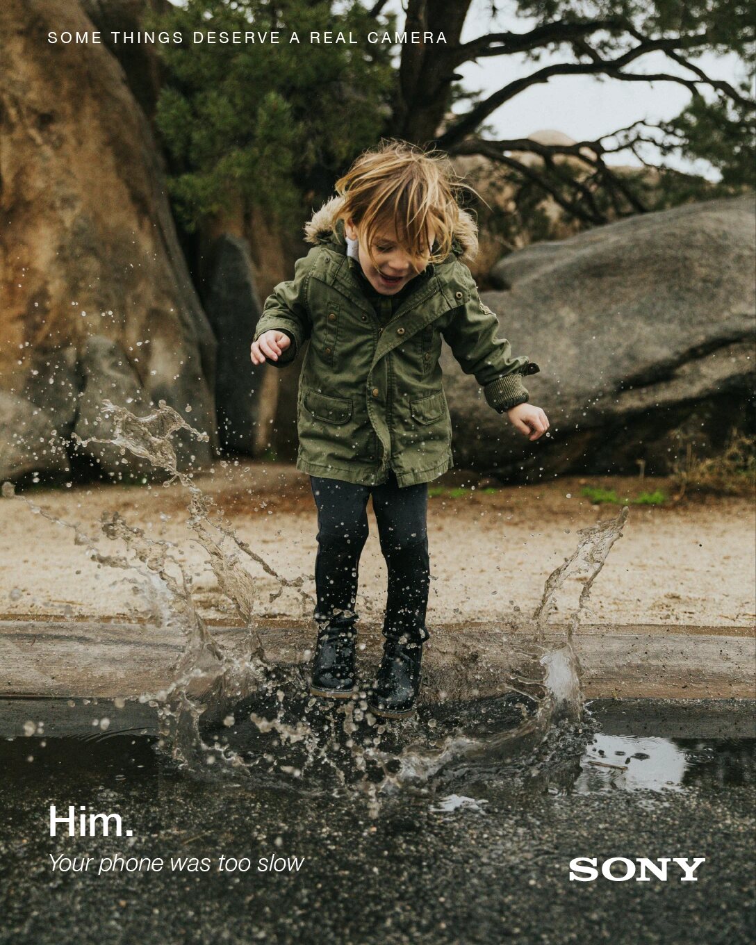 Sony 'Him.' poster: a child jumping in a puddle.